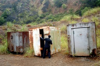 Photo of a member of the OIG Inspection Team examining explosives storage bunkers